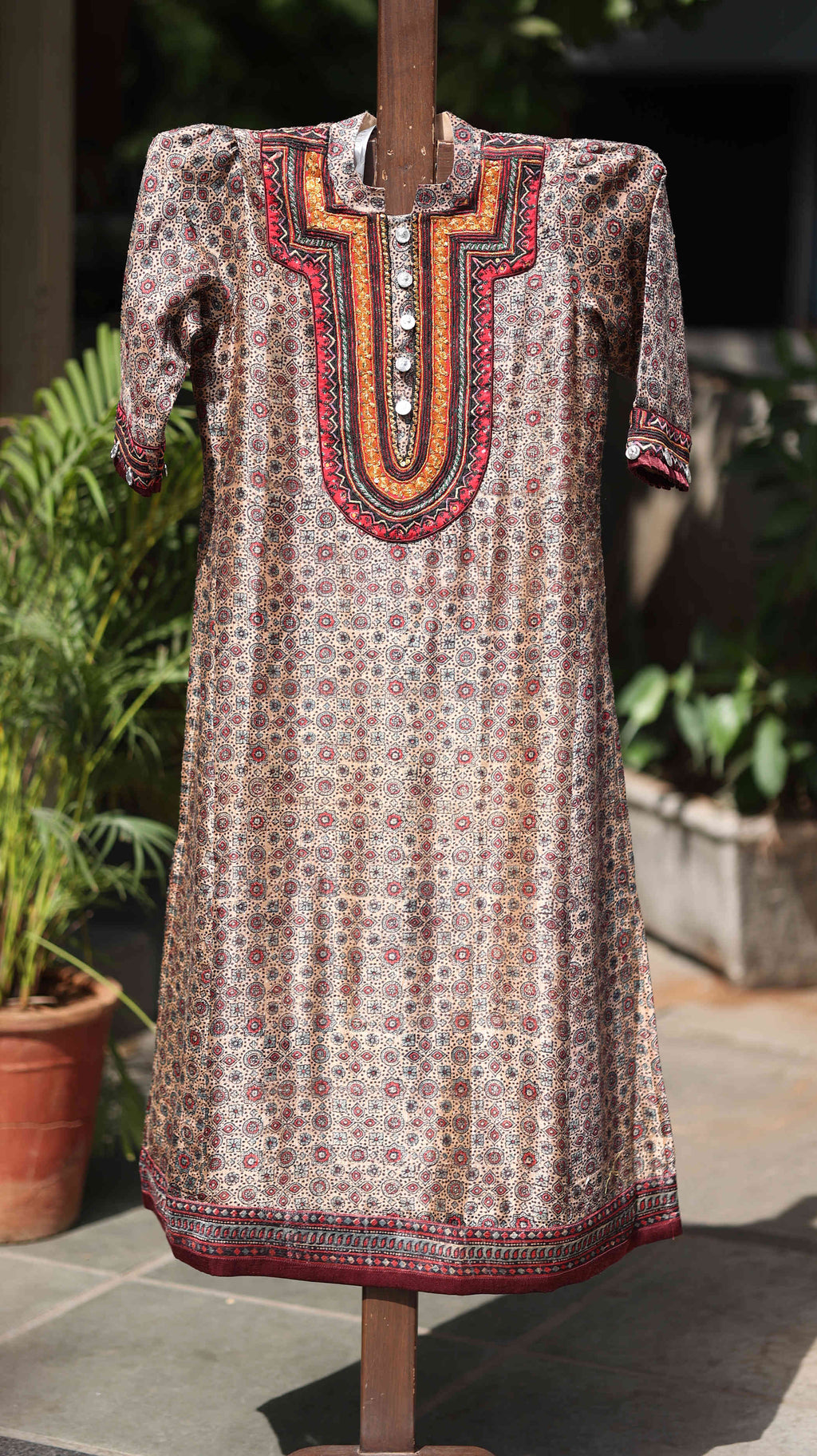 Traditional Red Kurti Set with Intricate Gold Embroidery and Bold Patterning