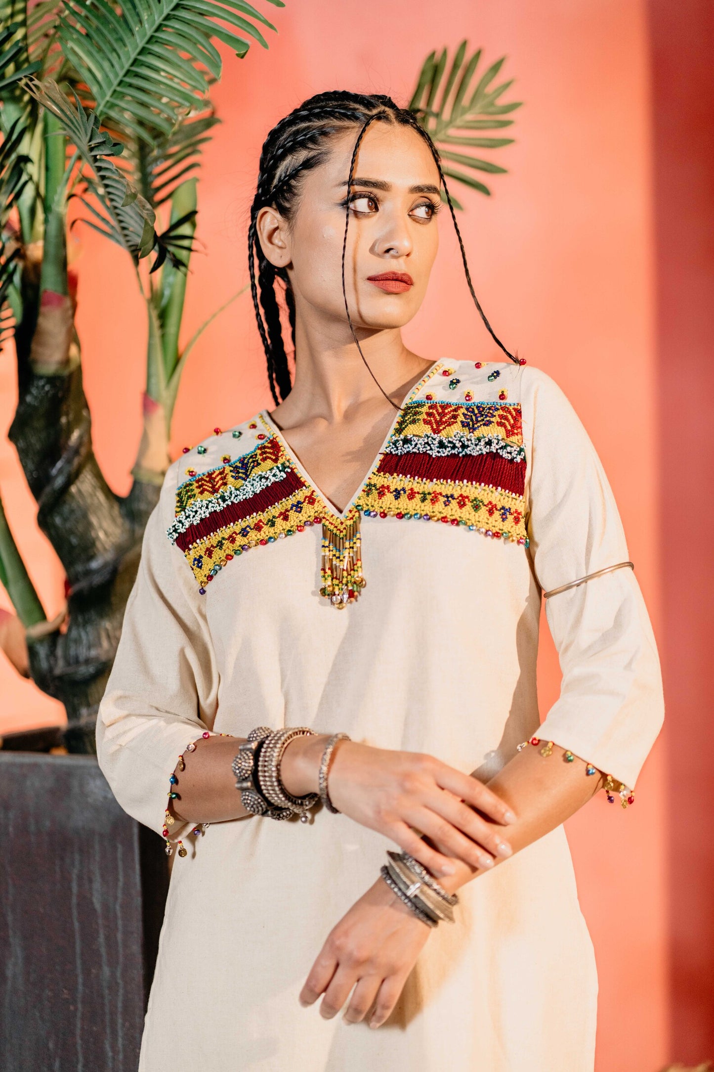 White yellow bead work kurti with same pants