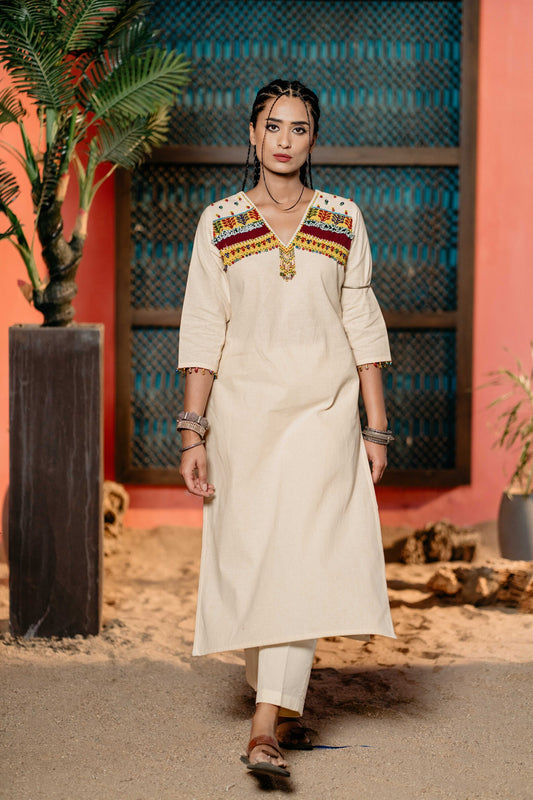 White yellow bead work kurti with same pants